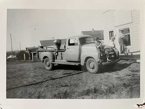 Black and white photo of workers and a truck